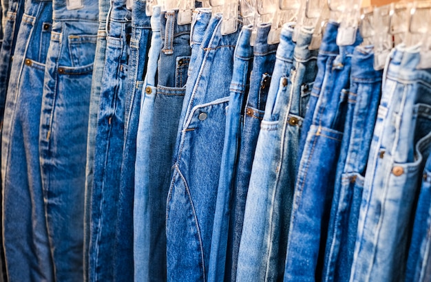 a-lot-of-jeans-hang-on-a-hanger-in-the-store-a-row-of-denim-pants-on-a-hanger-in-the-store-sale-of-jeans-in-the-store-on-the-counter-jeans-texture_131638-49.jpg
